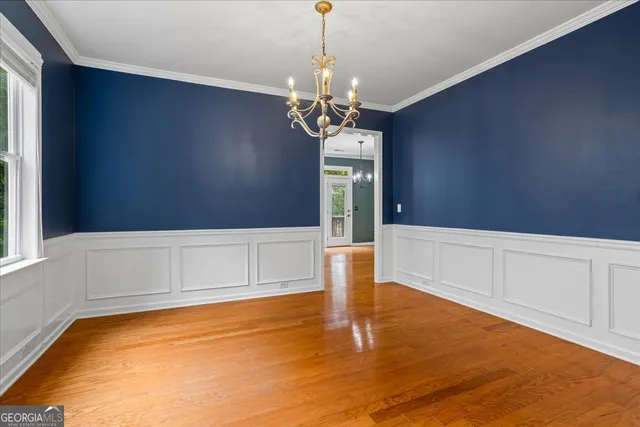 a kitchen with stainless steel appliances granite countertop wooden cabinets a refrigerator a sink a stove a microwave and island with wooden floor