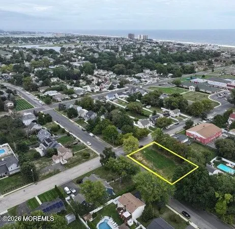 an aerial view of residential houses with city view