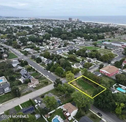 an aerial view of residential houses with city view