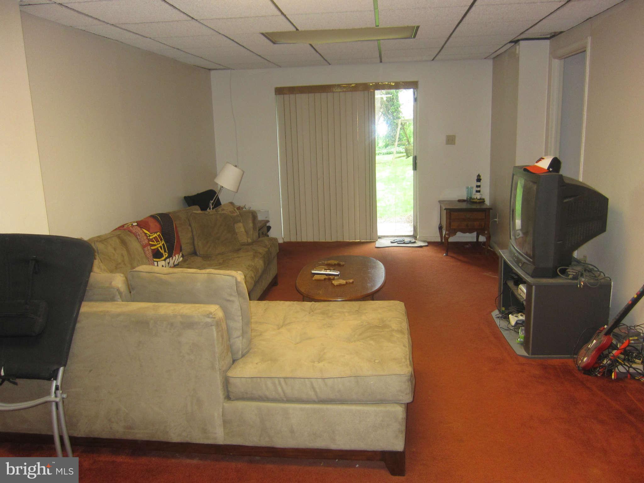 709 Bonifant Road Silver Spring, MD 20905 - Photo 20 of 29 Lower level recreation room, sliders to patio