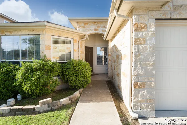 a view of a porch with plants and trees
