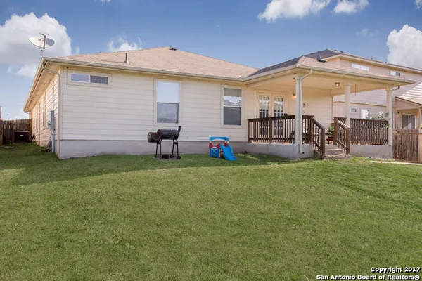 a view of a house with a backyard