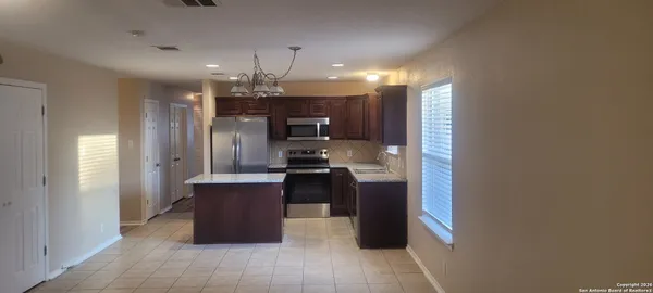 a kitchen with a refrigerator and a sink
