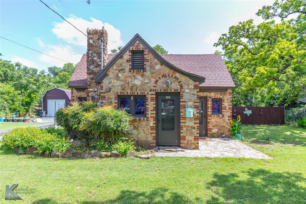 202 East Ross Street Rising Star, TX 76471 - Photo 2 of 40 a front view of a house with a yard and garage