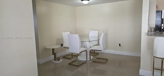 a view of a room with table and chairs