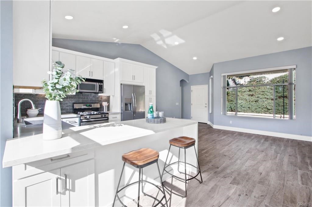 19431 Rue De Valore, Unit 49A Lake Forest, CA 92610 - Photo 12 of 23 a dining room with furniture and a kitchen view