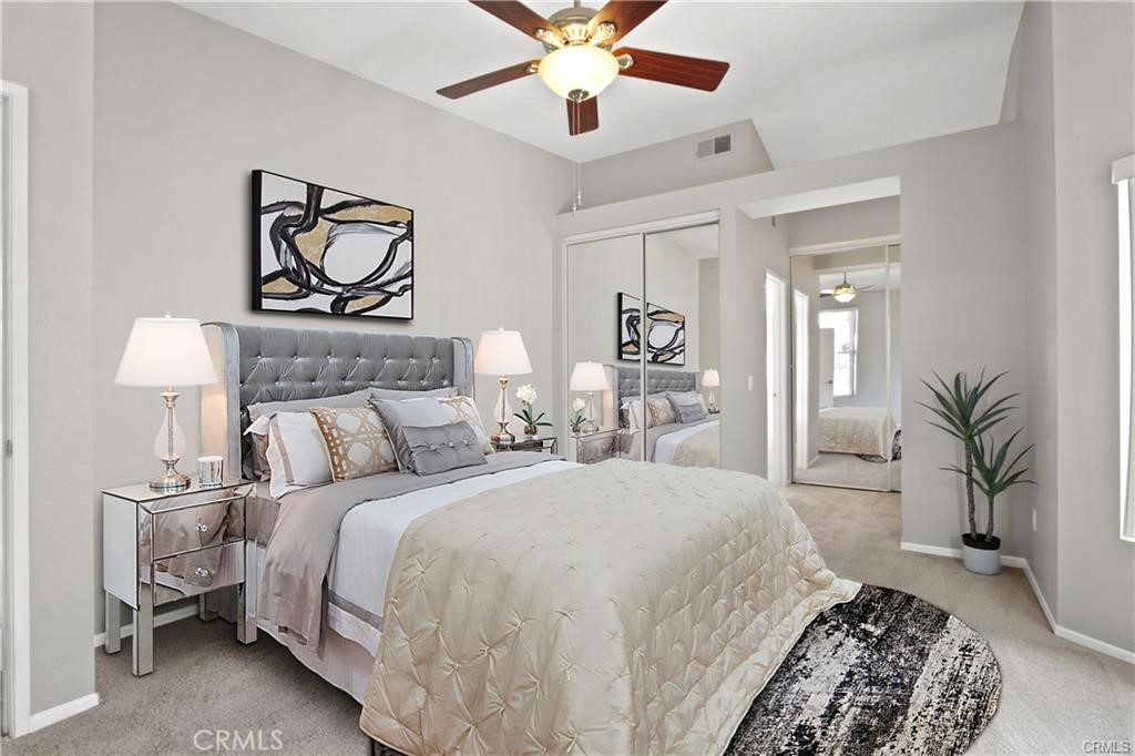 19431 Rue De Valore, Unit 49A Lake Forest, CA 92610 - Photo 13 of 23 a bedroom with bed and a chandelier