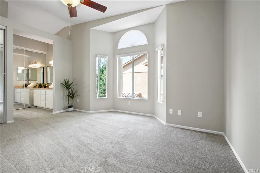 19431 Rue De Valore, Unit 49A Lake Forest, CA 92610 - Photo 14 of 23 an empty room with a kitchen and windows