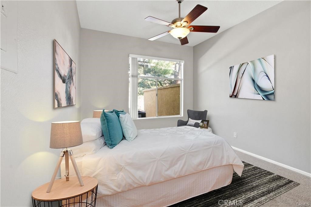 19431 Rue De Valore, Unit 49A Lake Forest, CA 92610 - Photo 17 of 23 a bedroom with a bed and a lamp on dresser