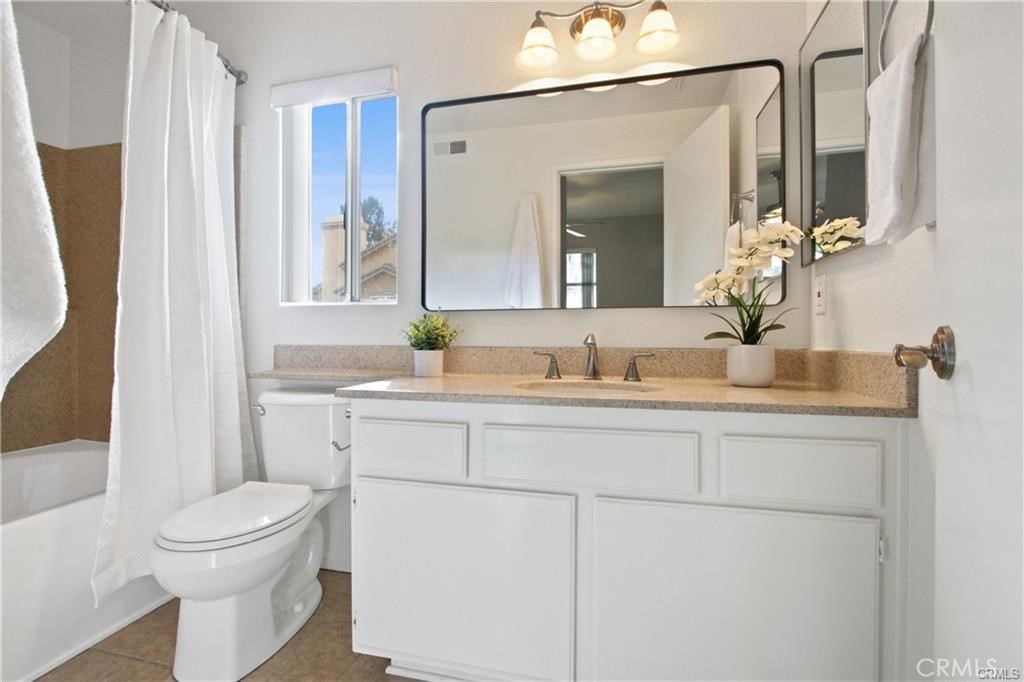 19431 Rue De Valore, Unit 49A Lake Forest, CA 92610 - Photo 19 of 23 a bathroom with a toilet a sink and a mirror