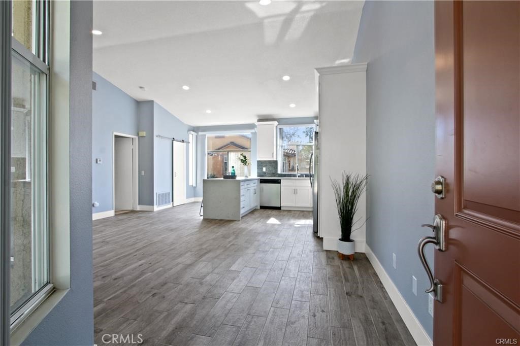 19431 Rue De Valore, Unit 49A Lake Forest, CA 92610 - Photo 2 of 23 a view of kitchen with refrigerator stove and wooden floor