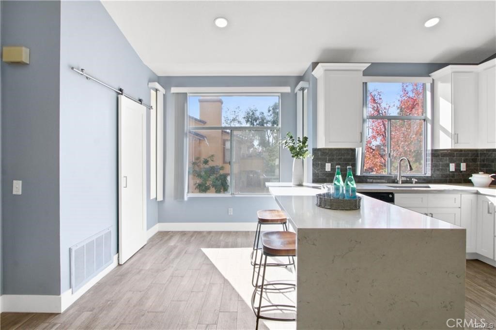 19431 Rue De Valore, Unit 49A Lake Forest, CA 92610 - Photo 8 of 23 a living room with furniture and large windows