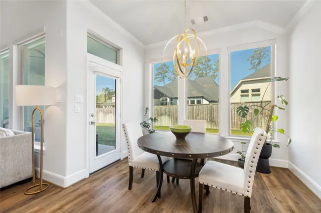 a bedroom with a bed ceiling fan and a large window