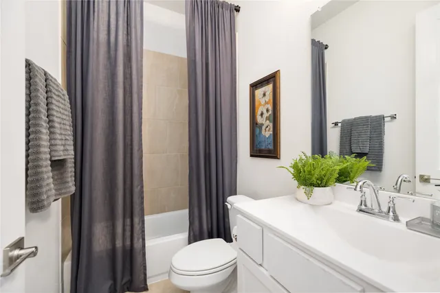 a bedroom with a bed and a flat tv screen on wall