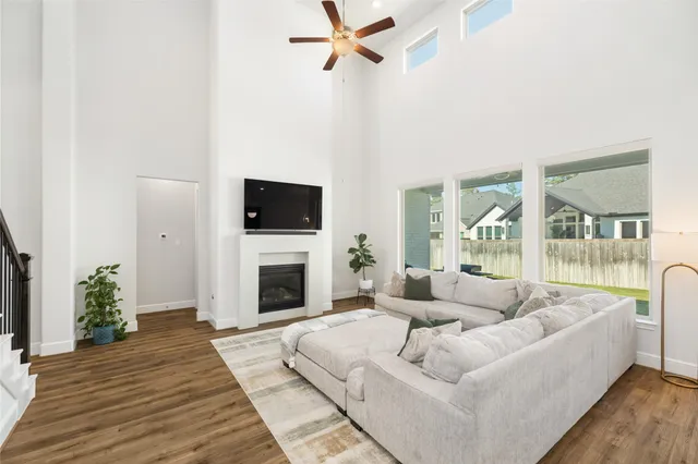 a kitchen with stainless steel appliances granite countertop a sink a stove a refrigerator and island with wooden floor