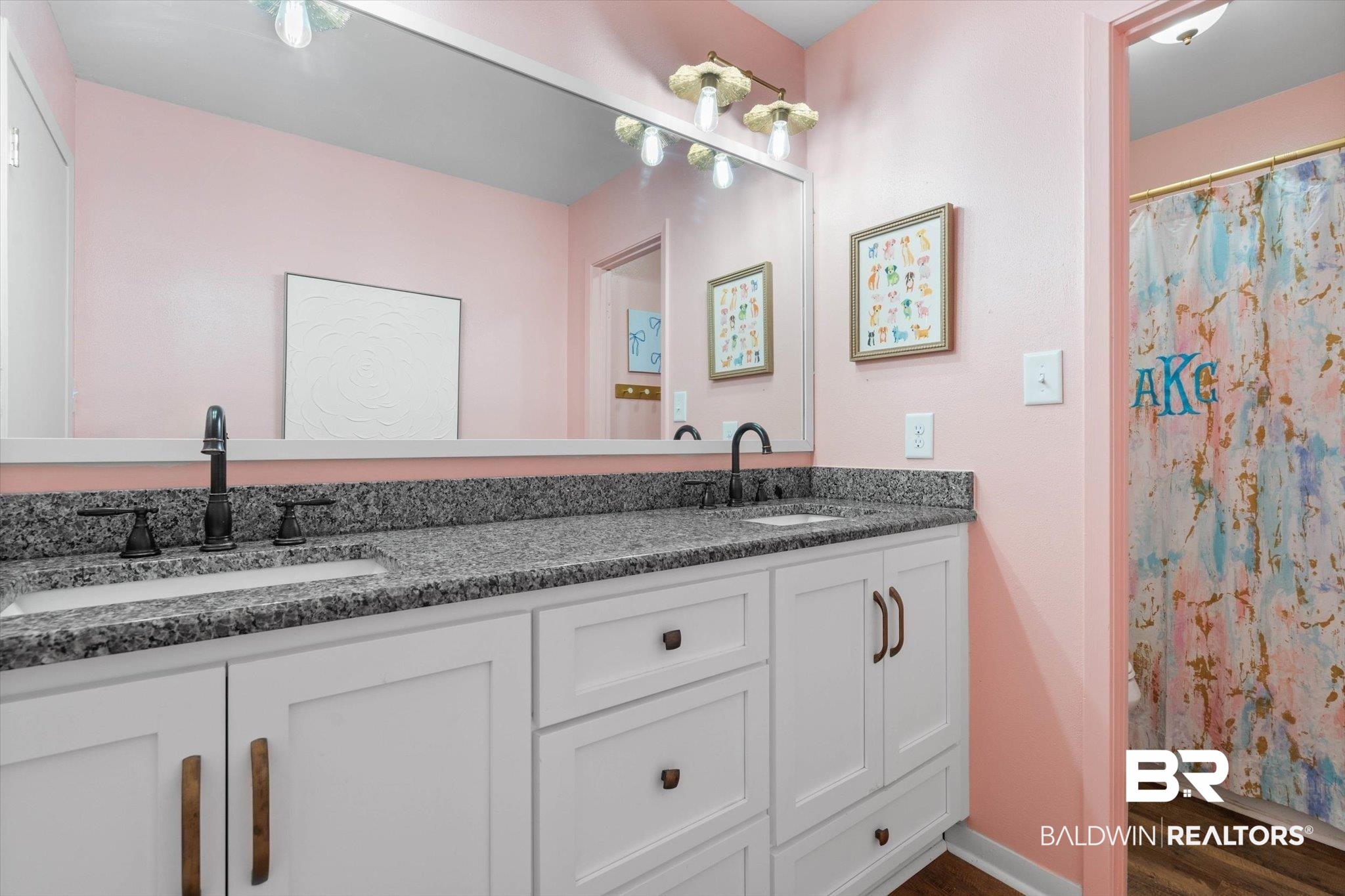 254 Woodlands Avenue Mobile, AL 36607 - Photo 30 of 50 Bathroom featuring double vanity, dark wood-style floors, and a shower with shower curtain