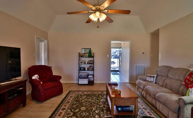 a living room with furniture and a rug