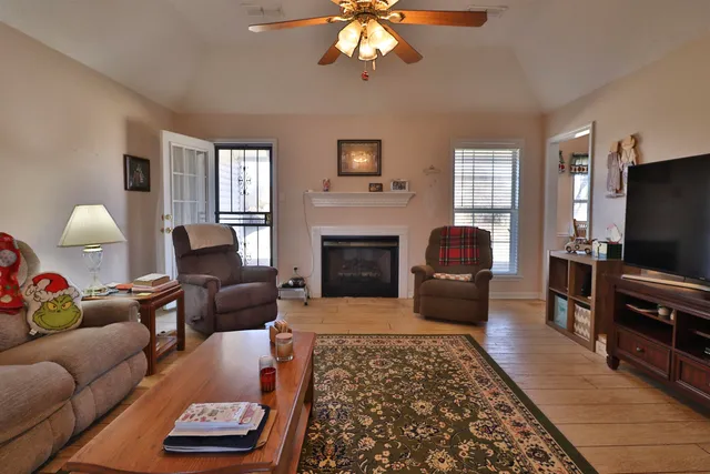 a living room with furniture fireplace and flat screen tv