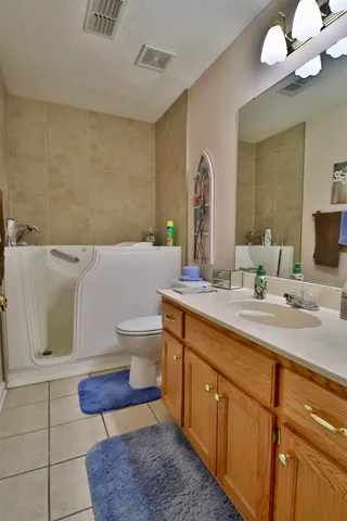 a bathroom with a sink a toilet and mirror