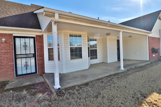 a view of a house with a door and wooden walls