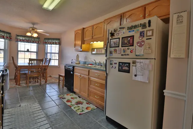 a kitchen with stainless steel appliances granite countertop a refrigerator and a stove