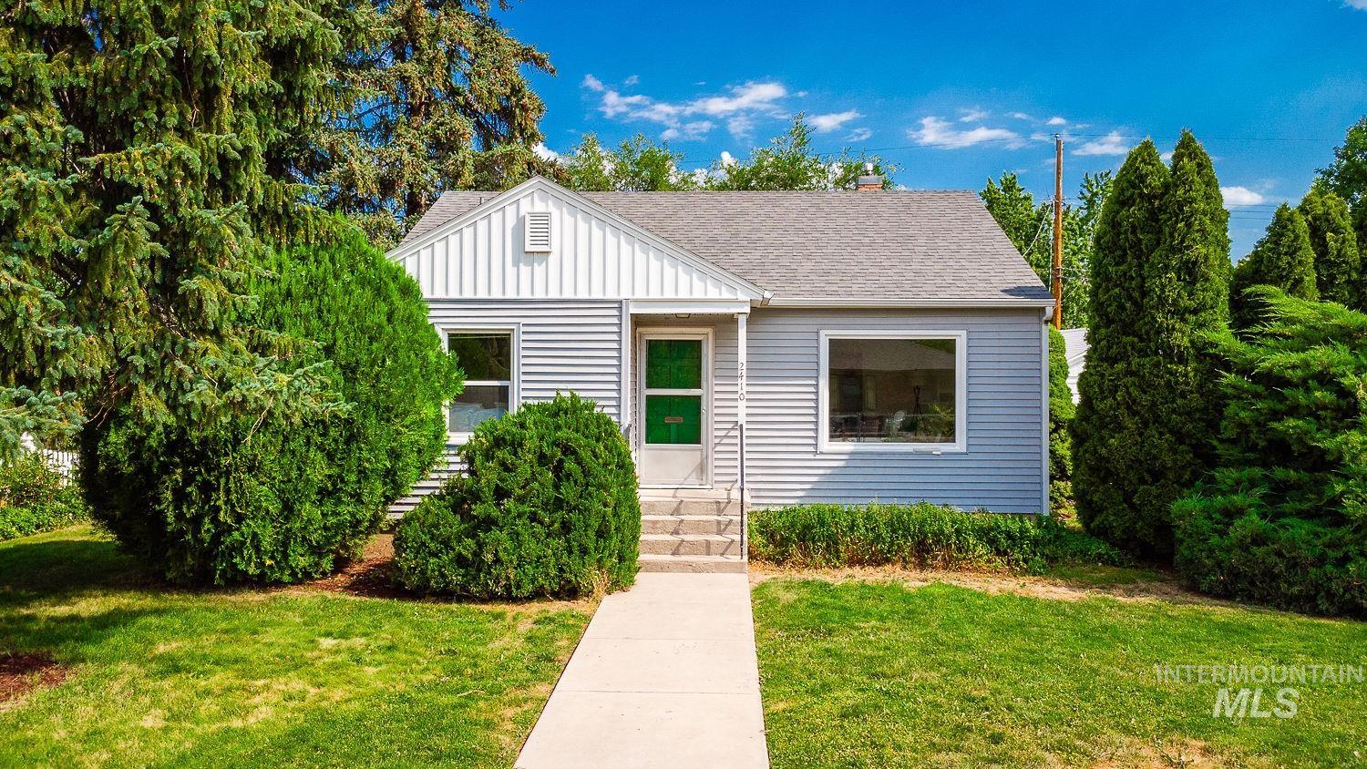2410 Pendleton Street Boise, ID 83705 - Photo 1 of 1 Bungalow featuring entry steps, a front lawn, roof with shingles, a chimney, and board and batten siding