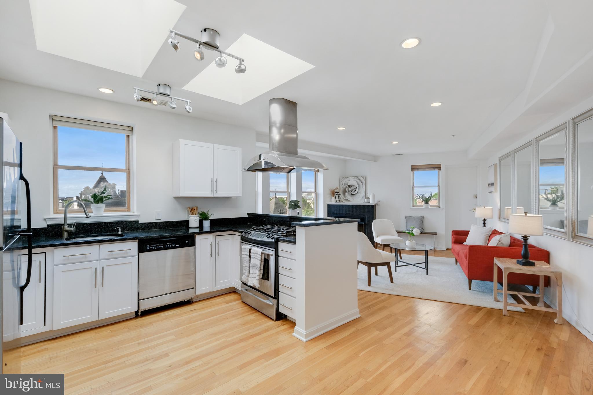 a kitchen with stainless steel appliances granite countertop a sink and cabinets
