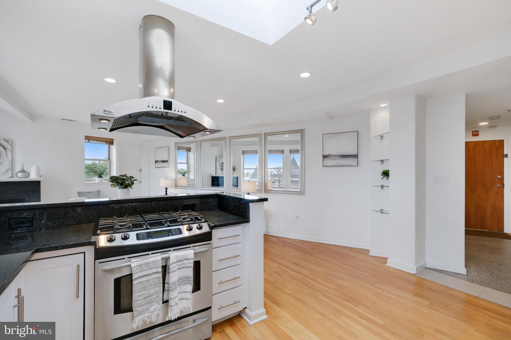 70 Rhode Island Avenue Northwest, Unit 502 Washington, DC 20001 - Photo 12 of 36 a kitchen with stainless steel appliances a stove and white cabinets