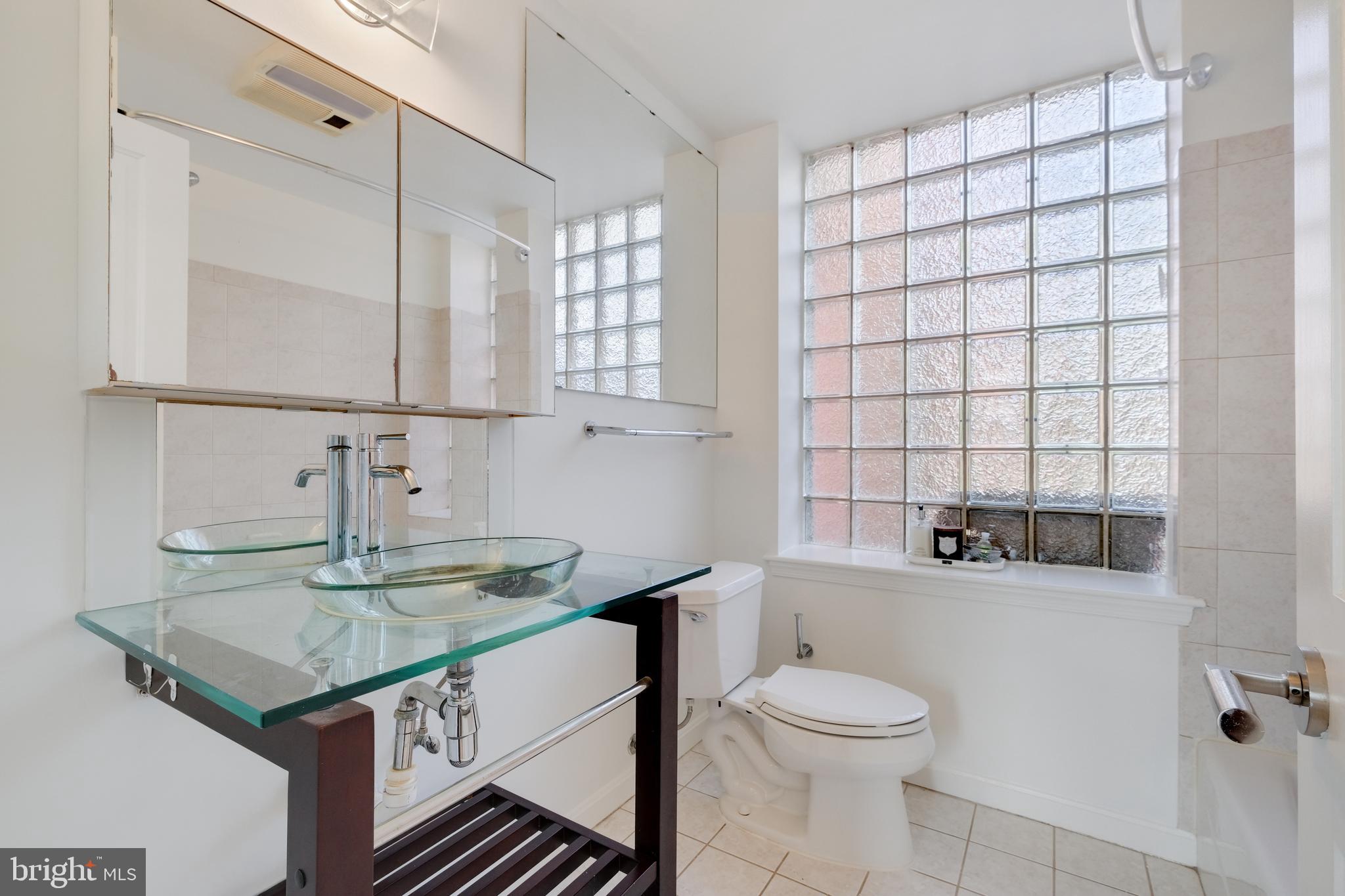 70 Rhode Island Avenue Northwest, Unit 502 Washington, DC 20001 - Photo 21 of 36 a bathroom with a granite countertop sink a toilet and bathtub