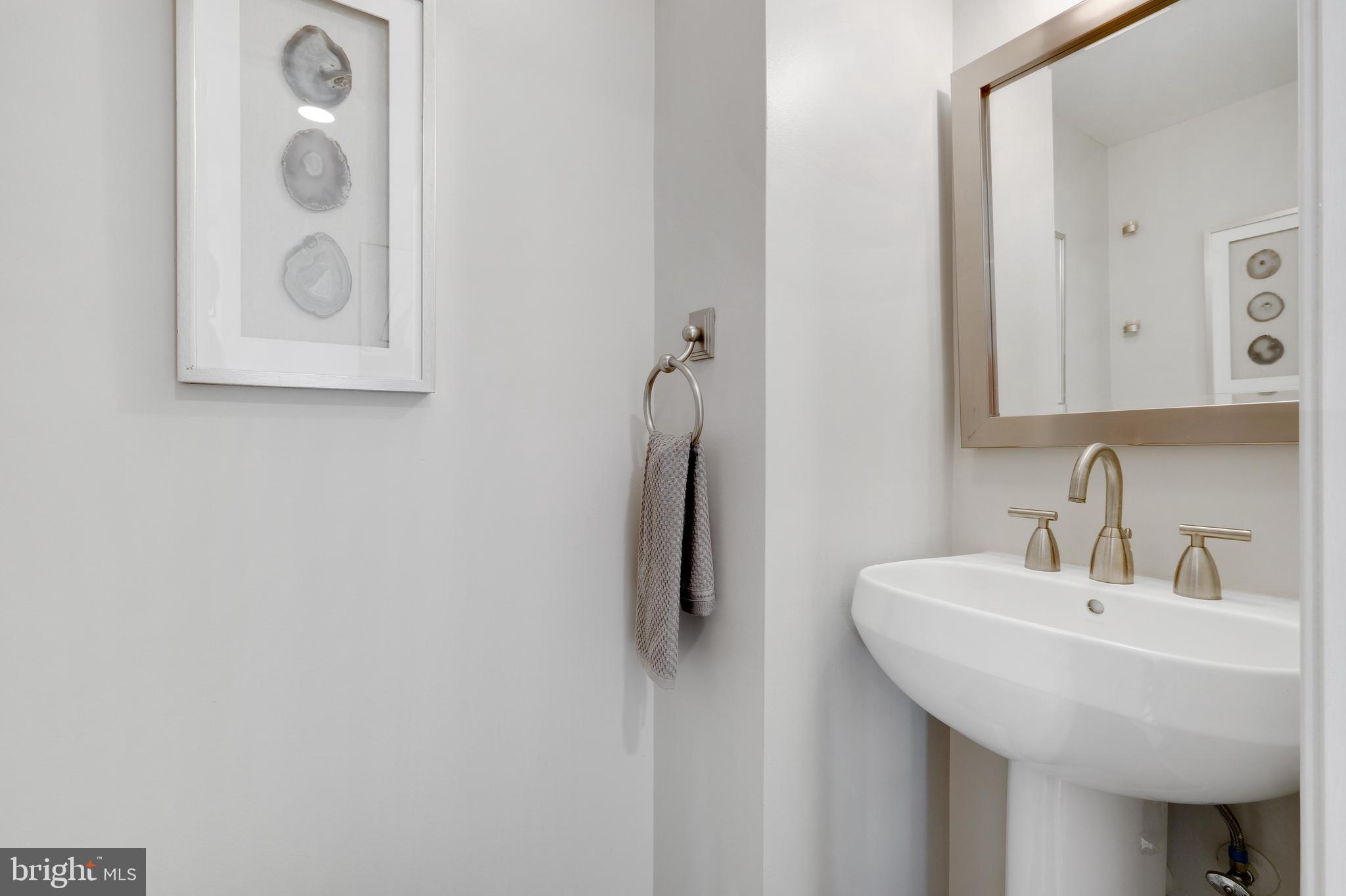 70 Rhode Island Avenue Northwest, Unit 502 Washington, DC 20001 - Photo 3 of 36 a bathroom with a sink and mirror