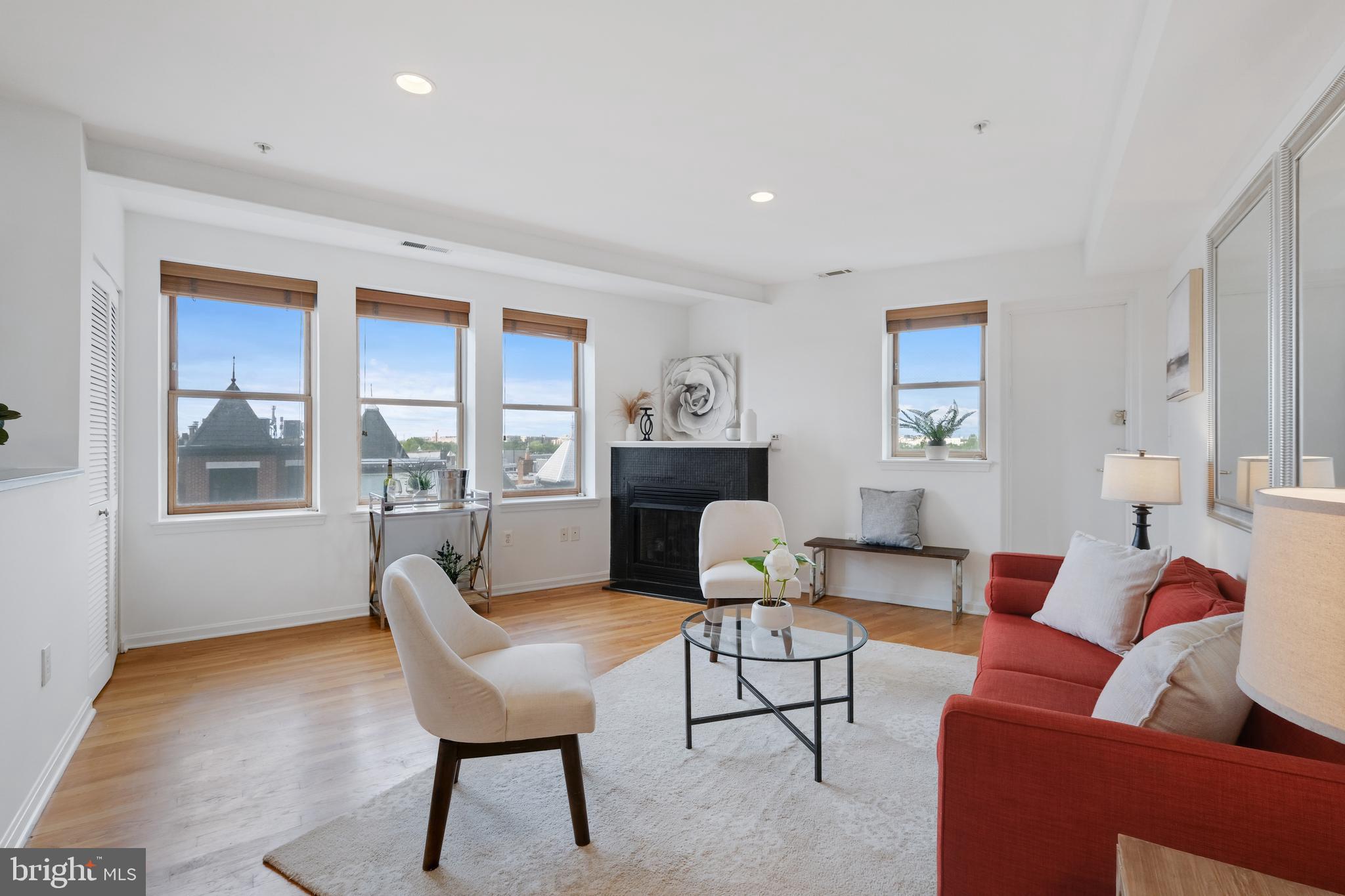 70 Rhode Island Avenue Northwest, Unit 502 Washington, DC 20001 - Photo 5 of 36 a living room with furniture and a fireplace