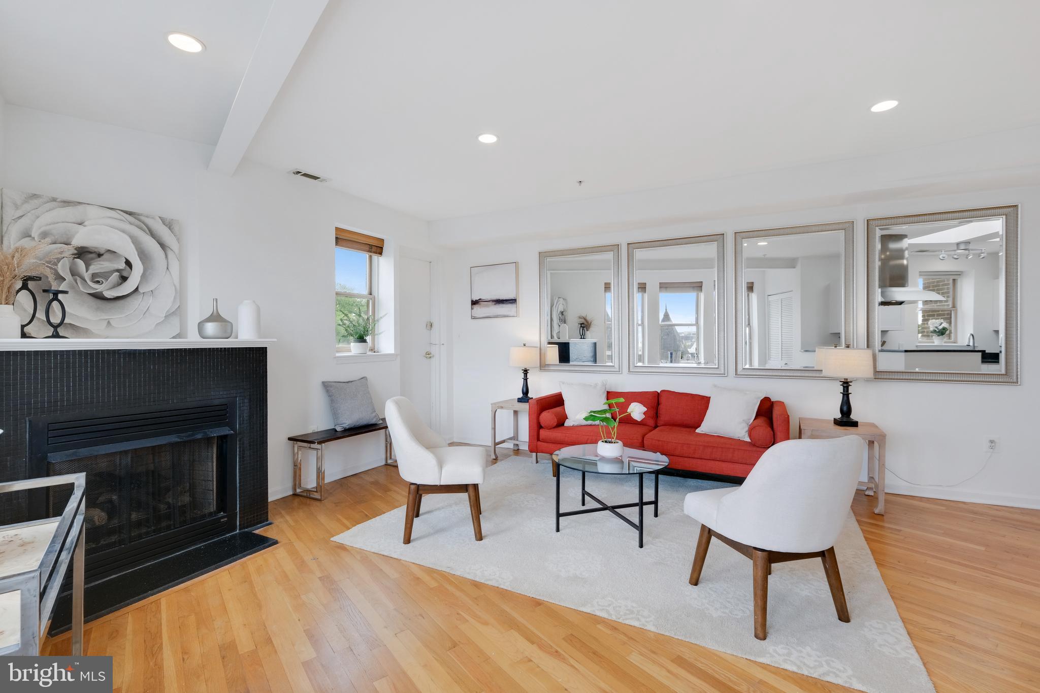 70 Rhode Island Avenue Northwest, Unit 502 Washington, DC 20001 - Photo 7 of 36 a living room with furniture a fireplace and a table