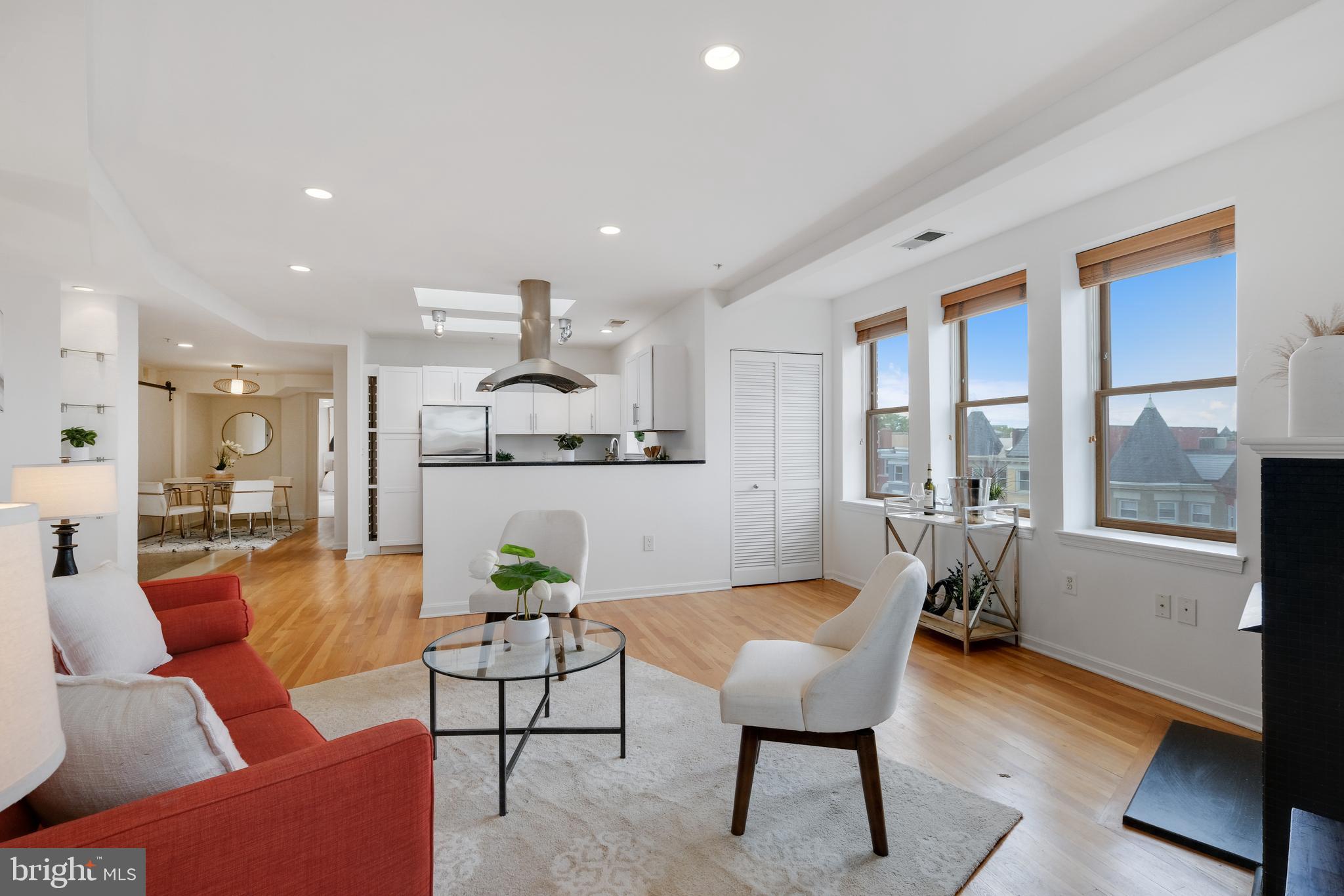 70 Rhode Island Avenue Northwest, Unit 502 Washington, DC 20001 - Photo 9 of 36 a living room with furniture and a large window