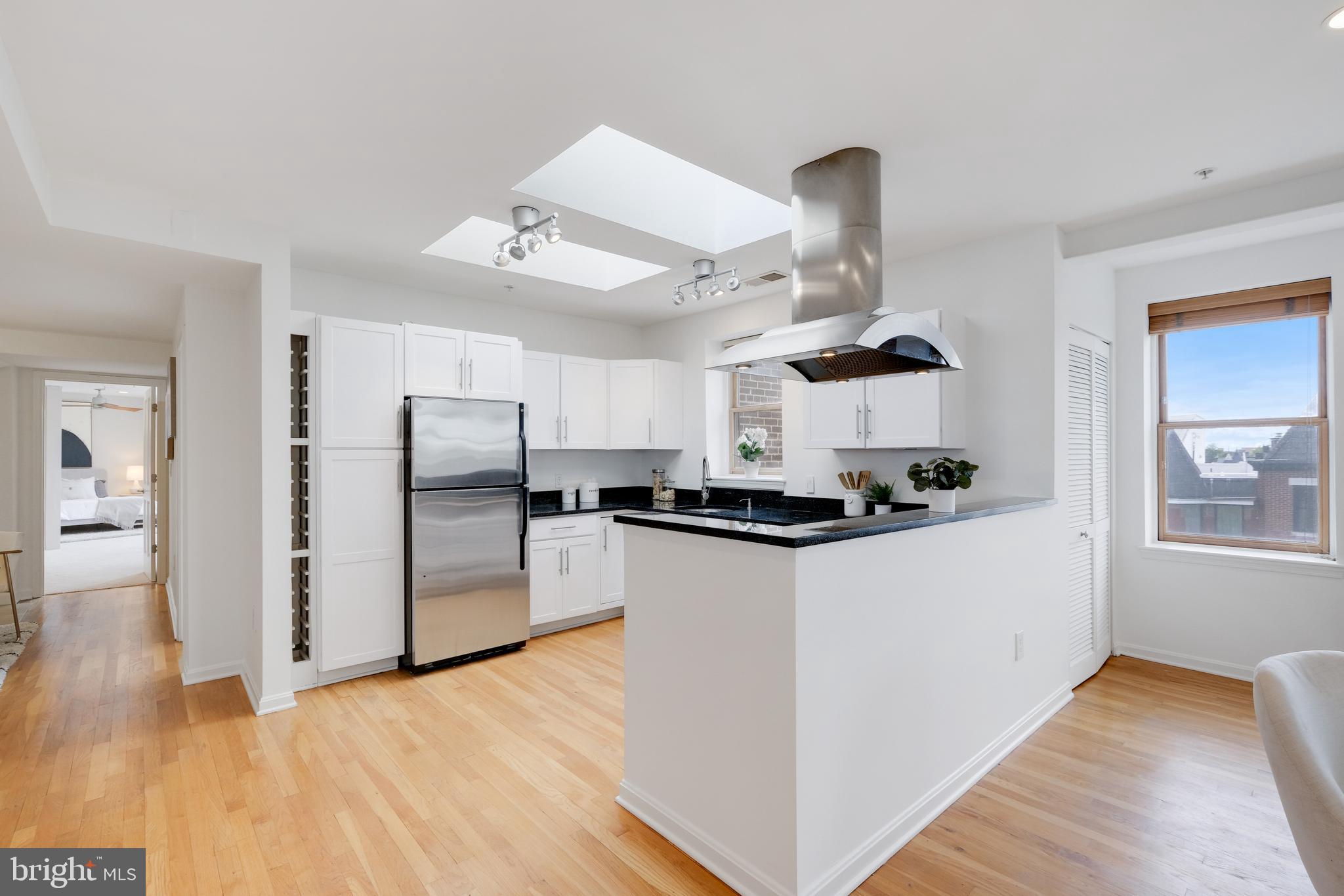70 Rhode Island Avenue Northwest, Unit 502 Washington, DC 20001 - Photo 10 of 36 a kitchen with stainless steel appliances a refrigerator a stove and white cabinets