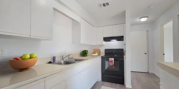 a kitchen with stainless steel appliances a refrigerator a sink and cabinets