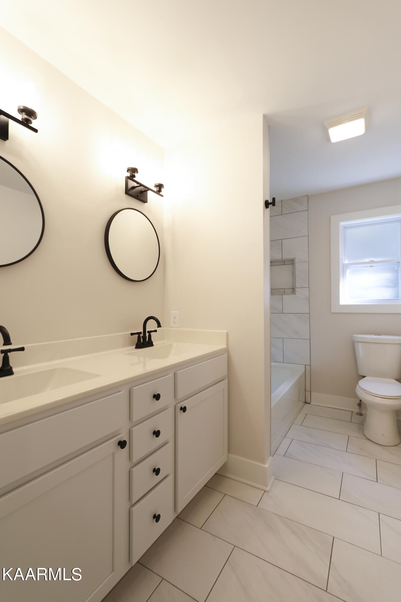 10604 Rutledge Pike Corryton, TN 37721 - Photo 12 of 19 a bathroom with a double vanity sink and a mirror