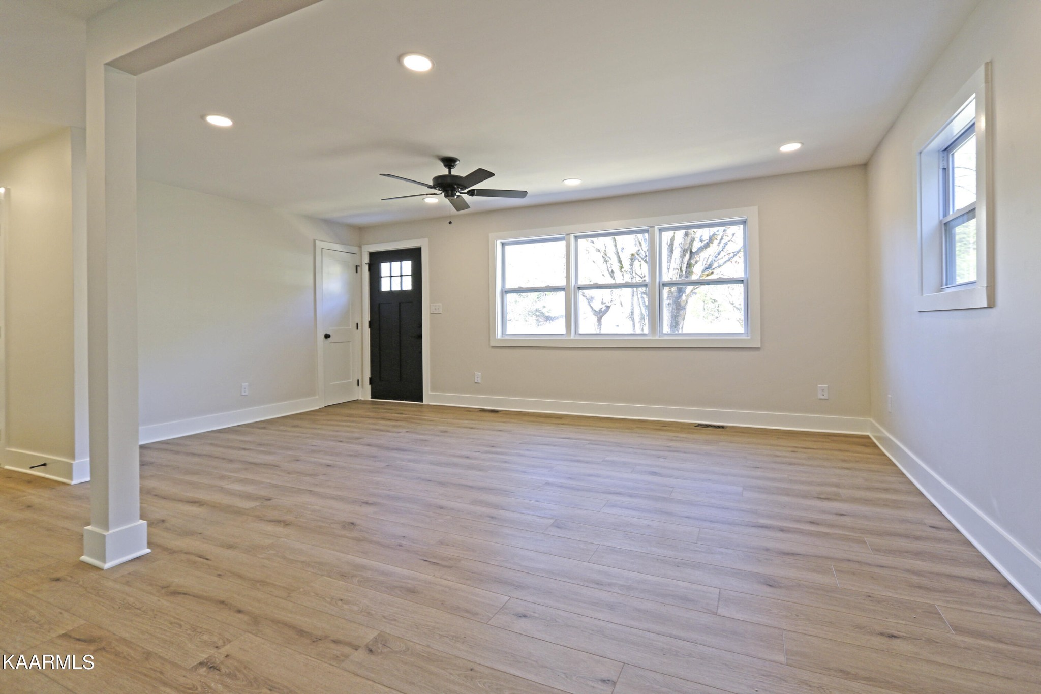 10604 Rutledge Pike Corryton, TN 37721 - Photo 5 of 19 an empty room with wooden floor and windows
