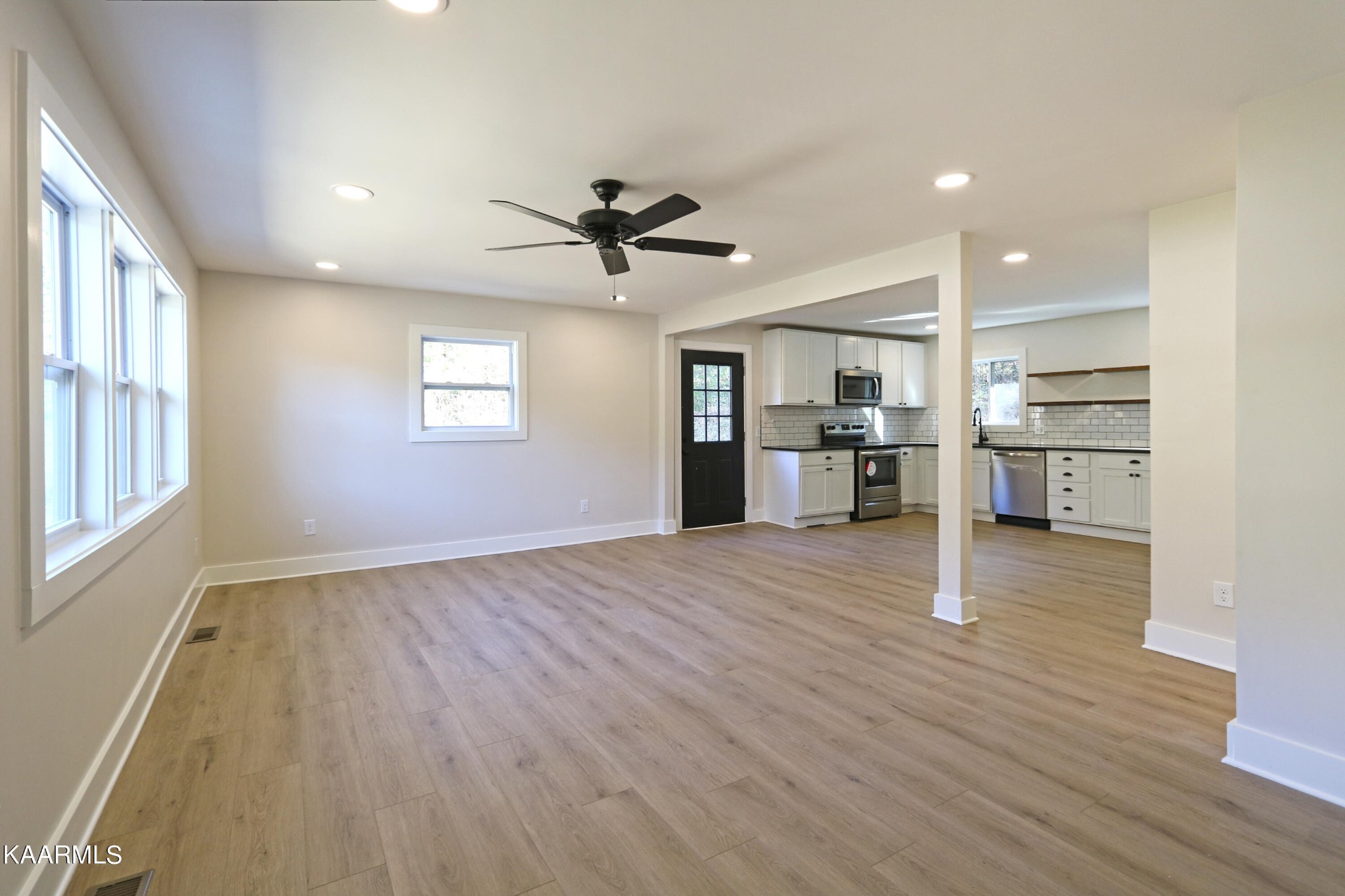 10604 Rutledge Pike Corryton, TN 37721 - Photo 6 of 19 a view of a kitchen with a wooden floor and a kitchen