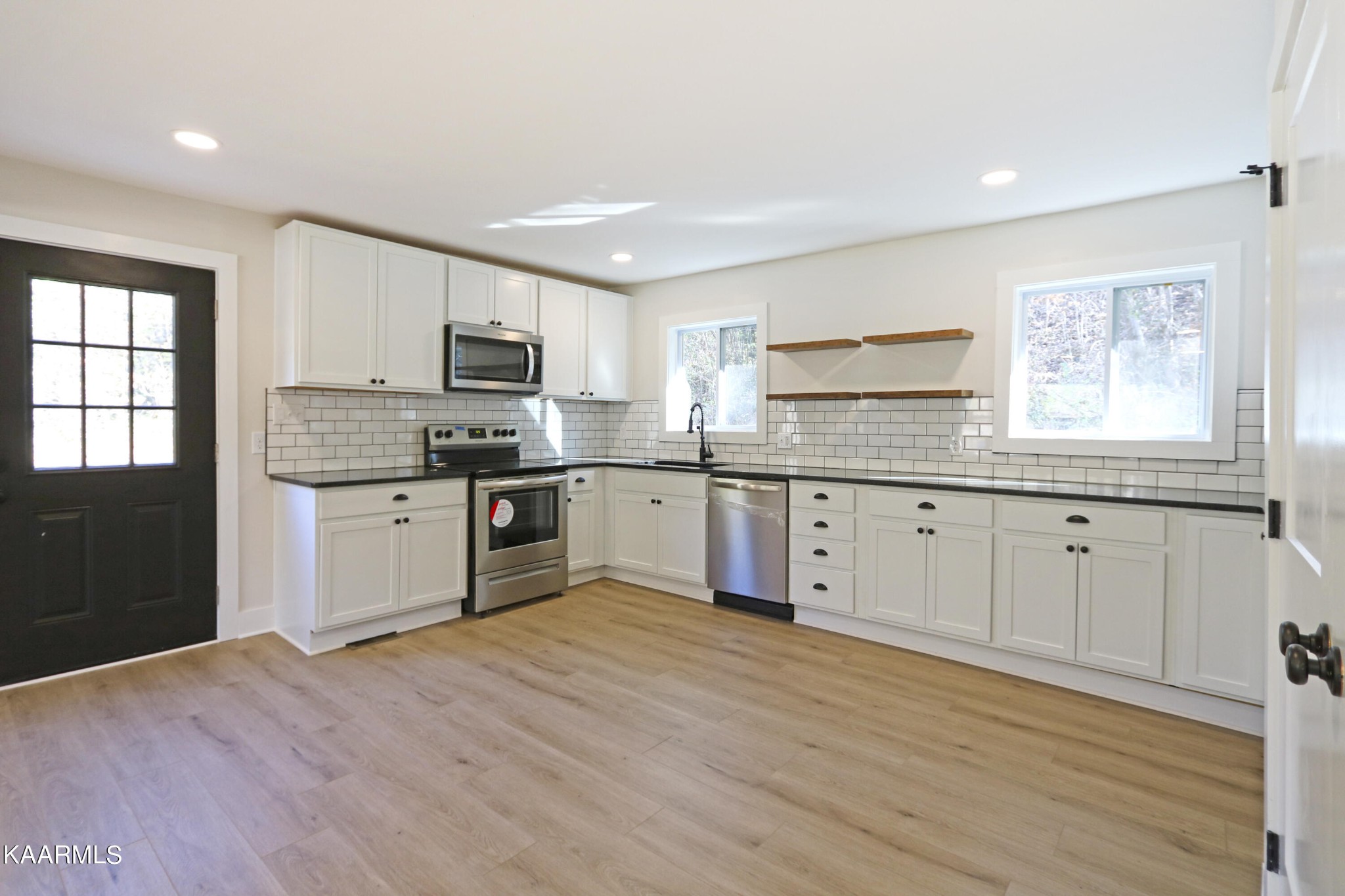 10604 Rutledge Pike Corryton, TN 37721 - Photo 8 of 19 a kitchen with granite countertop a stove top oven sink and cabinets
