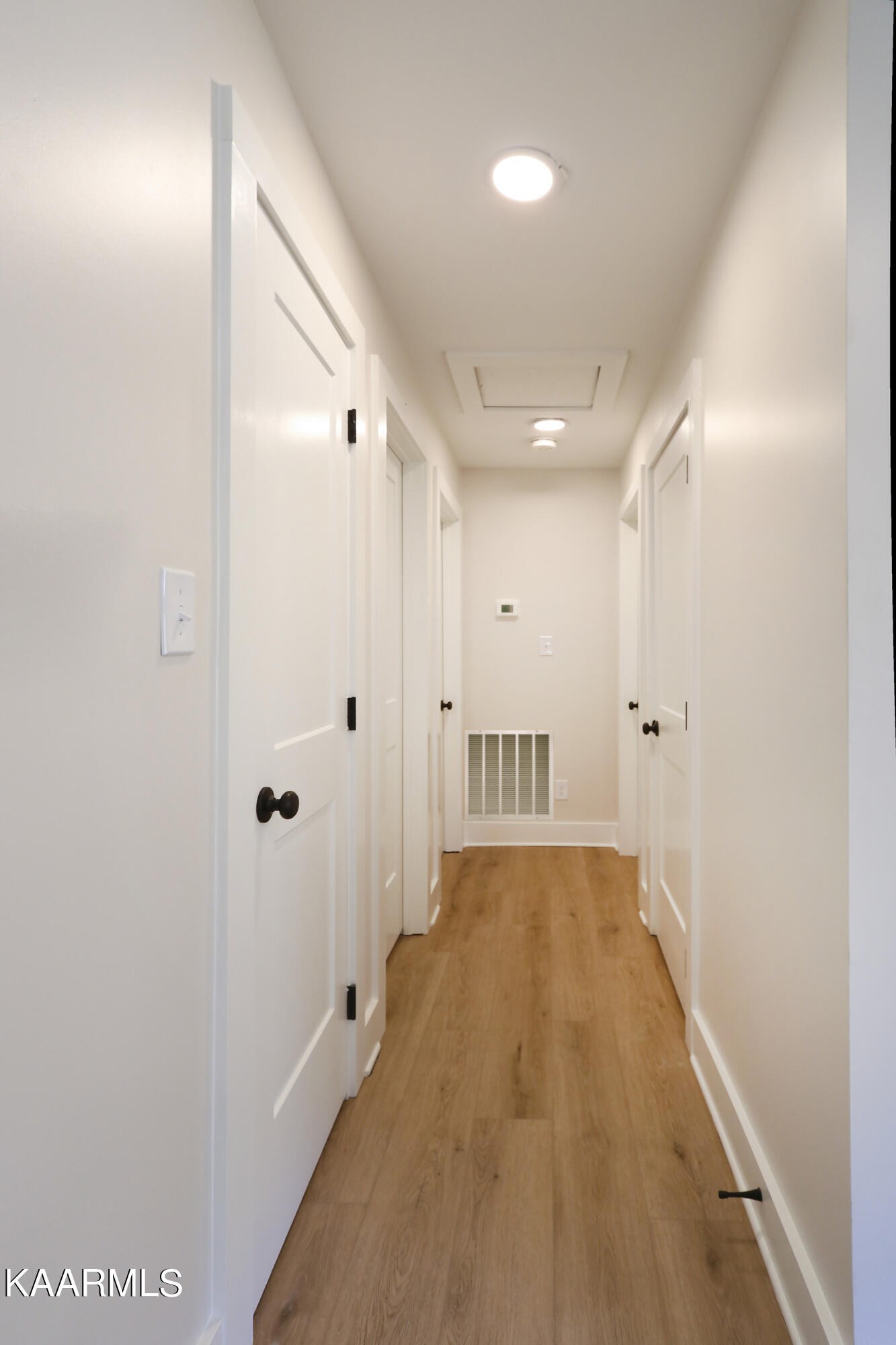 10604 Rutledge Pike Corryton, TN 37721 - Photo 9 of 19 a view of a hallway with wooden floor and a bathroom