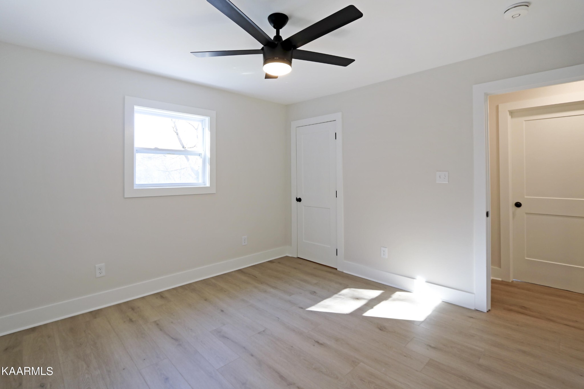 10604 Rutledge Pike Corryton, TN 37721 - Photo 10 of 19 an empty room with wooden floor and windows