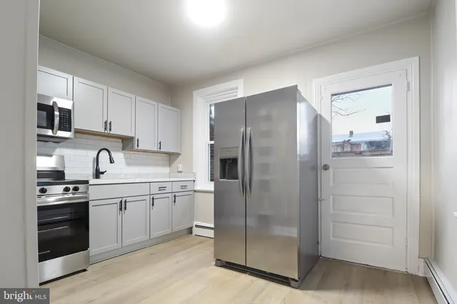 a kitchen with a sink cabinets and stainless steel appliances
