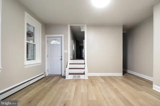 a view of a livingroom with wooden floor and a window