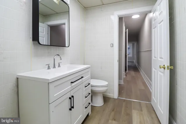 a bathroom with a toilet sink and mirror