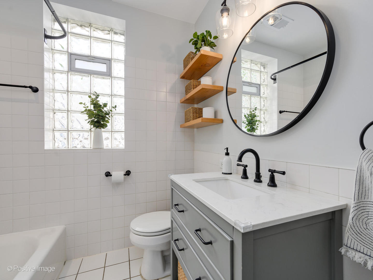 3903 North Seeley Avenue, Unit 3 Chicago, IL 60618 - Photo 15 of 20 a bathroom with a sink a mirror a toilet and a window