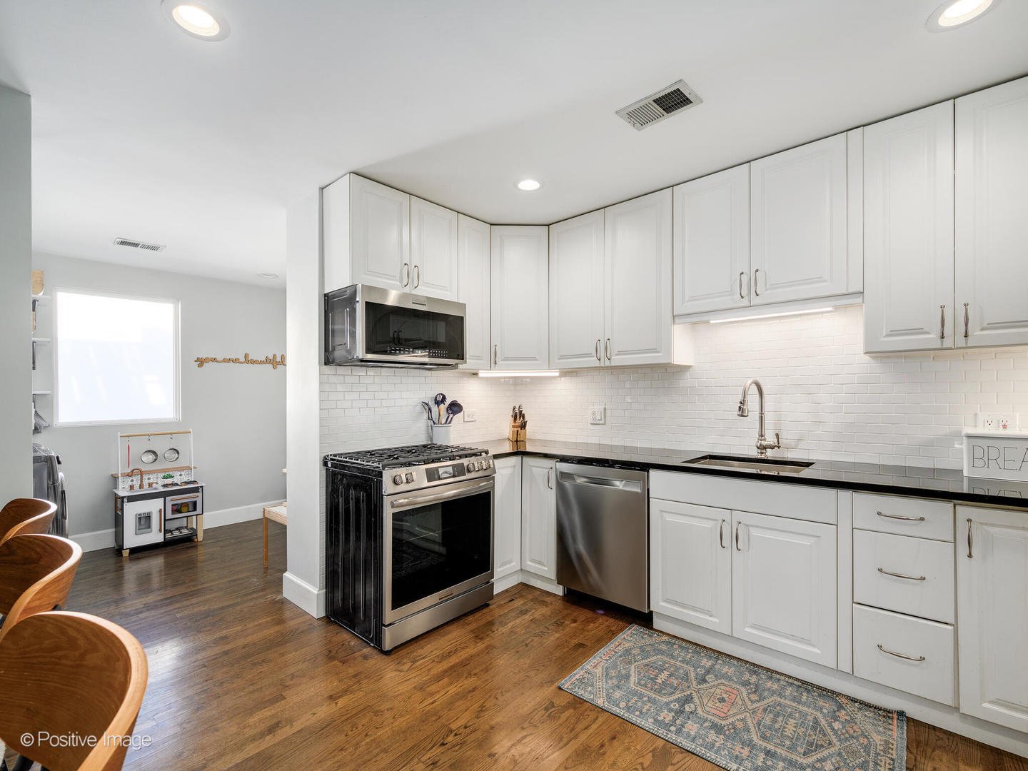 3903 North Seeley Avenue, Unit 3 Chicago, IL 60618 - Photo 8 of 20 a kitchen with stainless steel appliances granite countertop a stove sink and cabinets