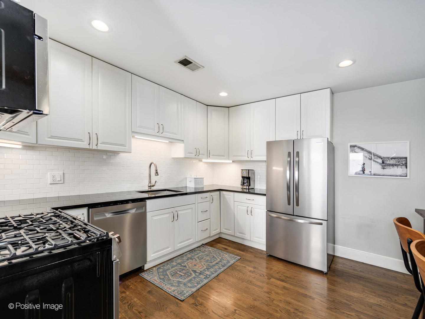 3903 North Seeley Avenue, Unit 3 Chicago, IL 60618 - Photo 9 of 20 a kitchen with stainless steel appliances granite countertop a sink stove and refrigerator