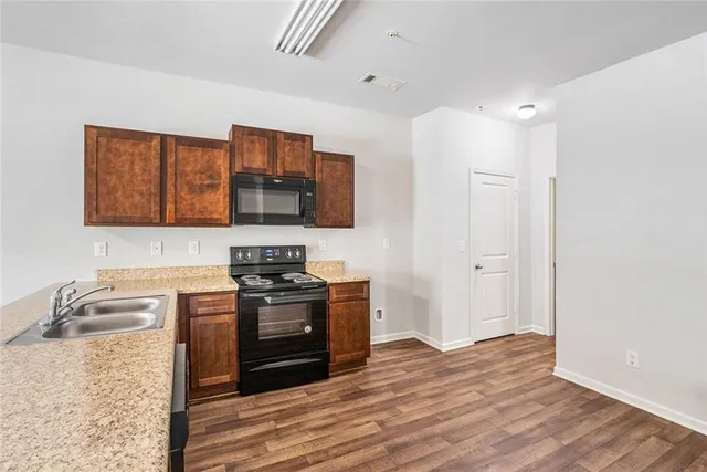 a kitchen with stainless steel appliances granite countertop a stove and a sink
