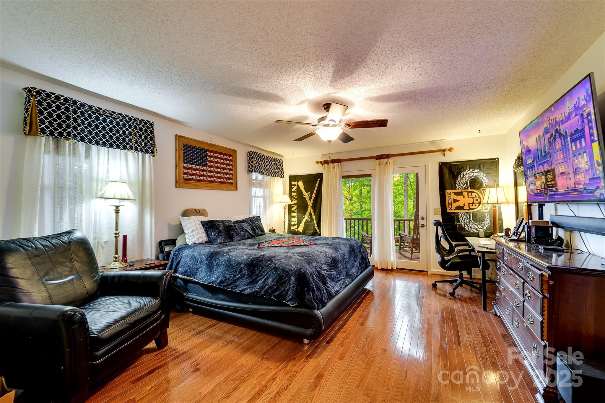 831 Forest Run Road Whittier, NC 28789 - Photo 16 of 29 a spacious bedroom with a bed window and couch