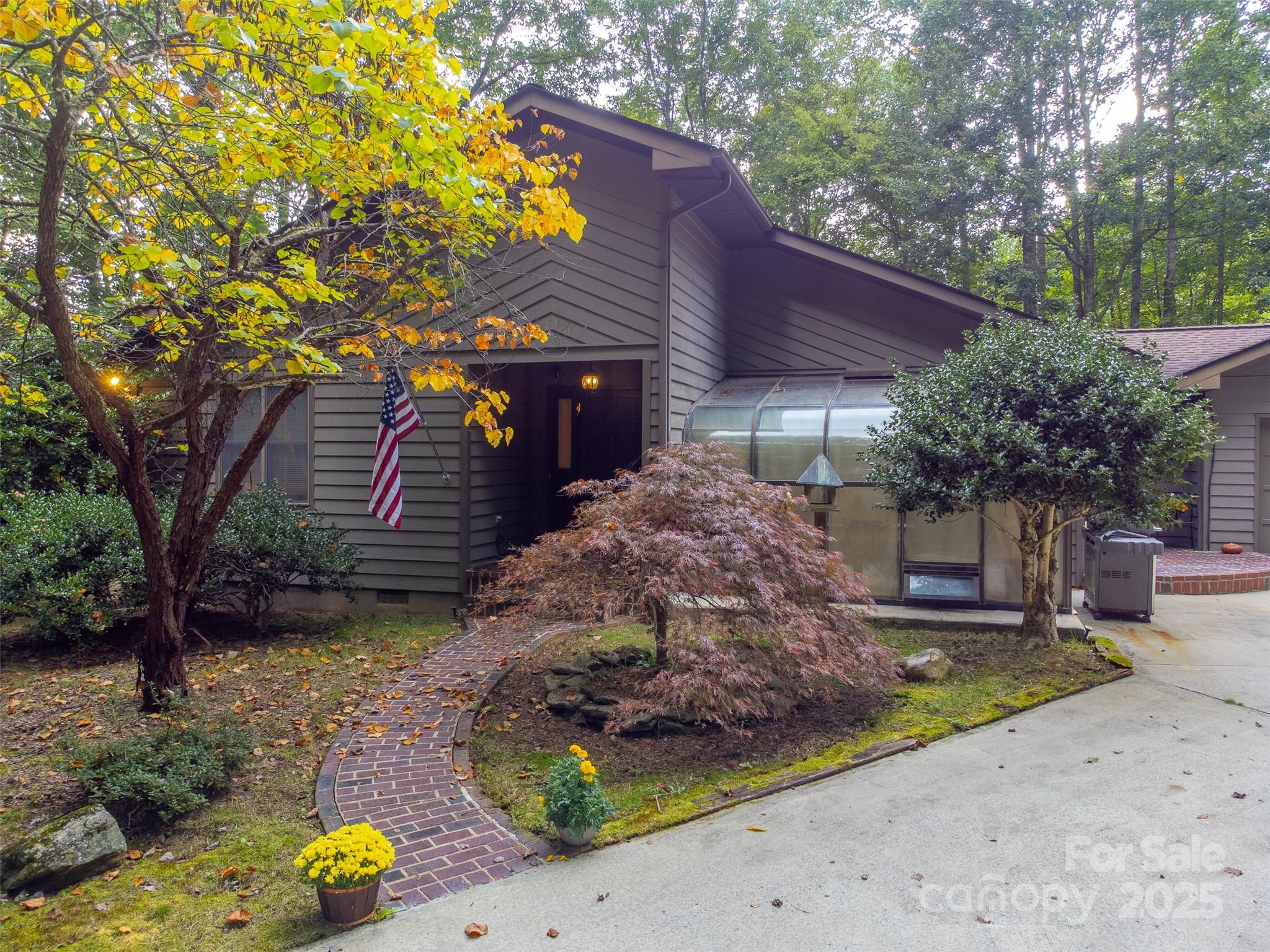 831 Forest Run Road Whittier, NC 28789 - Photo 20 of 29 a front view of a house with garden